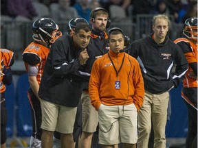 VANCOUVER, BC - DECEMBER 5, 2015, -  Mt. New Westminster Hyacks head coach Darnell Sikorski (centre wearing orange) with ass coach Farhan Lalji vs Douglas Rams vs.  in  (AAA) Jr. Varsity Final at BC Place Stadium in Vancouver, BC. December 4, 2015. (Arlen Redekop / PNG photo) (story by Howard Tsumura) 00040590B [PNG Merlin Archive]