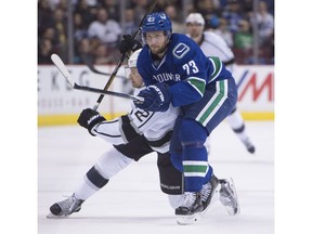 Left-shot Vancouver Canucks defenceman Alexander Edler, front, had a horrible time when John Tortorella moved him to the right side.
