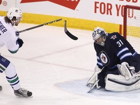 The shot heard around Grenier’s world: The Canucks’ Alex Grenier breaks his stick while trying to finish off a breakaway against Winnipeg Jets goalie Ondrej Pavelec last March 22 in Winnipeg. ‘All my buddies bring it back to me all the time,’ Grenier says ruefully.