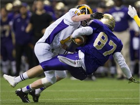 Mt. Douglas Rams middle linebacker Quinn Jenish, shown laying a hit on Vancouver College in the Subway Bowl 2015 final, is back as the B.C. champs' lone returning defensive starter. Gerry Kahrmann/PNG files