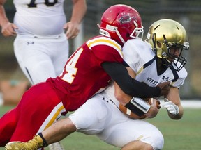 W.J. Mouat Hawks' Cam'ron Lobban (left) tackles Everett Seagulls' receiver Josiah Chavez during senior varsity high school football opener for both teams Friday in Abbotsford. (Gerry Kahrmann, PNG photo) [PNG Merlin Archive]