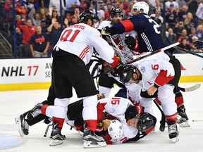 Jonathan Toews #16 of Team Canada tackles Ryan Kesler #17 of Team USA after a big hit during the second period of an exhibition game. (Jamie Sabau/World Cup of Hockey via Getty Images)