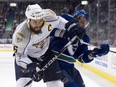 Nashville's then-captain, Shea Weber, rubs out the Canucks' Chris Higgins during their playoff series in May, 2011. Little did people know that Higgins was playing on a foot referred to as "shattered glass."