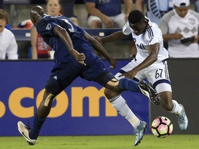 Vancouver Whitecaps midfielder Pedro Morales, right, challenges Sporting Kansas City forward Diego Rubio during Tuesday's CONCACAF Champions League game in K.C.