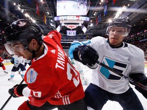 TORONTO , ON - SEPTEMBER 27: Defenceman Christian Ehrhoff #10 of Team Europe battles for the puck against forward John Tavares #20 of Team Canada during Game One of the World Cup of Hockey final series at the Air Canada Centre on September 27, 2016 in Toronto, Canada.