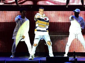 Justin Bieber, center, performs on the Virgin Media Stage during the V Festival at Hylands Park in Chelmsford, Britain, Saturday, Aug. 20, 2016. The Stratford, Ont.-born pop superstar dropped the microphone and stopped his Manchester, England show after pleading with fans to tone down their screams. THE CANADIAN PRESS/AP, Ian West/PA via AP