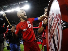 Toronto FC&#039;s Michael Bradley bangs on a drum after his team defeated the Philadelphia Union in MLS soccer playoff action in Toronto, Wednesday October 26, 2016. There is finally something to celebrate at Toronto FC as the MLS club won its first ever playoff game, 3-1 over the Union. THE CANADIAN PRESS/Mark Blinch