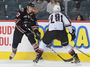 Jordy Stallard of the Calgary Hitmen tries to make a pass around Darian Skeoch of the Vancouver Giants, during Monday's game at the Saddledome. (Calgary Sun photo.)