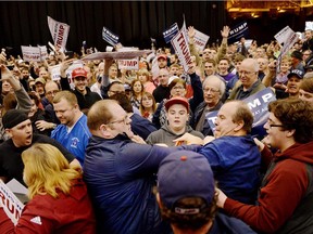 A protester, center left, and a Trump supporter, center right, scuffle during a rally for Republican presidential candidate Donald Trump in Cleveland in March. A USA Today poll suggests that there were will be violence on election night in the U.S.