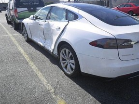 After a sideswiping accident, this 2014 Tesla S sports sedan had to be written off due to the high costs of replacing damaged parts.