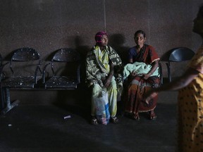 Indian woman carries an infant at the Modern Government Maternity Hospital in Hyderabad. India has one of the world's worst records on maternal health care, with 200 women dying during pregnancy or childbirth for every 100,000 patients, compared with China's 37 deaths for every 100,000 women who give birth.