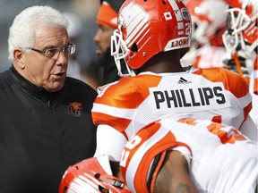 B.C. Lions coach Wally Buono talks to Ryan Phillips during the first half of CFL action against the Blue Bombers in Winnipeg on Saturday. Buono was mic'd-up during the game.