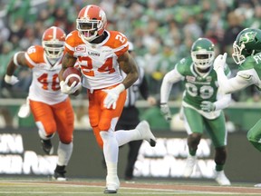 B.C. Lions running back Jeremiah Johnson (24) moves the ball up field against the Saskatchewan Roughriders during the first half in Regina on Saturday.