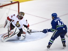 Ottawa Senators goalie Craig Anderson (41) stops a shot from Vancouver Canucks left wing Sven Baertschi (47) during third period NHL action in Vancouver, B.C. Tuesday, Oct. 25, 2016.
