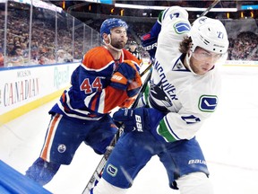 Ben Hutton and Zack Kassian clash along the boards.