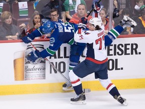 Vancouver Canucks' Bo Horvat, back, and Washington Capitals' T.J. Oshie collide during the second period of Saturday's game at Rogers Arena.