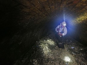 Sewer supervisor Vince Minney works in a London sewer in 2014. Every day beneath the streets of London, sewer cleaners wage a grim war against giant "fatbergs" clogging the system. It's also a problem in Metro Vancouver.