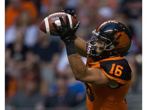 B.C. Lions' Bryan Burnham makes a reception against the Hamilton Tiger-Cats during the first half of a CFL football game in Vancouver, B.C., on Saturday August 13, 2016.