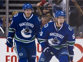 VANCOUVER, BC - OCTOBER 10: Bo Horvat #53 of the Vancouver Canucks celebrates after scoring a goal against the Calgary Flames as Sven Baertschi #47 looks on in NHL action on October, 10, 2015 at Rogers Arena in Vancouver, British Columbia, Canada.