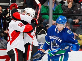 Goal scorer Ryan Dzingel of the Senators is congratulated while Troy Stecher of the Canucks skates away during their NHL game at Rogers Arena October 25, 2016 in Vancouver, British Columbia, Canada.