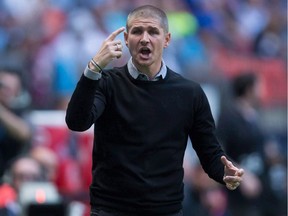 Vancouver Whitecaps' head coach Carl Robinson argues a call with an official during the first half of an MLS soccer game against the Chicago Fire in Vancouver, B.C., on Wednesday May 11, 2016. With his team battling for its Major League Soccer playoff life, Whitecaps head coach Robinson was asked if Tuesday nights' CONCACAF Champions League match was a distraction.