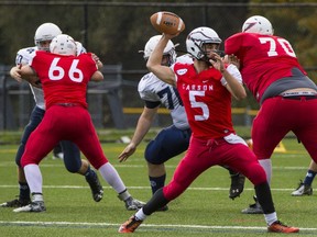 Carson Graham quarterback Sterling Storey looks to pass downfield during his team's loss to the Notre Dame Jugglers on Friday in North Vancouver.