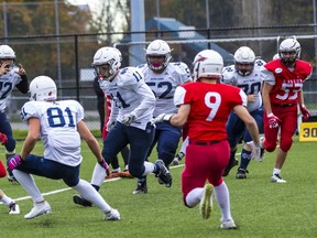 Notre Dame (white) and Carson Graham renewed their long rivalry Friday in North Vancouver. (Francis Georgian, PNG Photo)