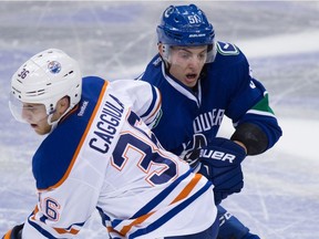 Will Troy Stecher, right, make the Canucks? He looked the part against the Oilers.