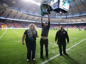 Seattle Sounders supporters hoist the Cascadia Cup to other fans after the team defeated the Vancouver Whitecaps last September at B.C. Place. The trophy was created by fans of the Vancouver Whitecaps, Seattle Sounders and Portland Timbers and is awarded to the best soccer team in the Pacific Northwest each MLS season.