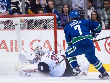 Arizona Coyotes' goalie Louis Domingue, left, stops Vancouver Canucks' Tuomo Ruutu, of Finland, during the first period of a pre-season NHL hockey game in Vancouver, B.C., on Monday October 3, 2016.