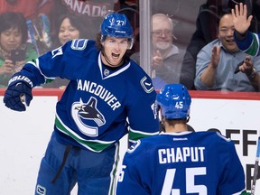 Vancouver Canucks' Ben Hutton, back, and Michael Chaput celebrate Hutton's goal against the Arizona Coyotes during the second period of a pre-season NHL hockey game in Vancouver, B.C., on Monday October 3, 2016.