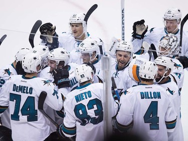 San Jose Sharks' Matt Nieto (83) and his teammates celebrate his winning goal during the overtime period of a pre-season NHL hockey game against the Vancouver Canucks in Vancouver, B.C., on Sunday October 2, 2016.
