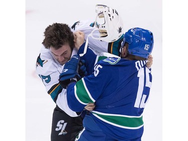 San Jose Sharks' Alex Gallant, left, loses his helmet while fighting Vancouver Canucks' Derek Dorsett during the second period of a pre-season NHL hockey game in Vancouver, B.C., on Sunday October 2, 2016.
