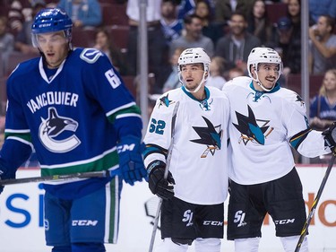 San Jose Sharks' Kevin Labanc, back left, and Matt Nieto, back right, celebrate Nieto's goal as Vancouver Canucks' Borna Rendulic looks on during the first period of a pre-season NHL hockey game in Vancouver, B.C., on Sunday October 2, 2016.
