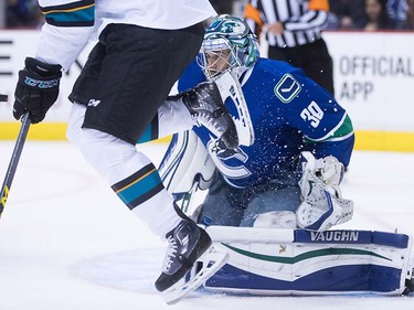 Vancouver Canucks' goalie Ryan Miller makes a save as San Jose Sharks' Chris Tierney tries to screen him during the first period of a pre-season NHL hockey game in Vancouver, B.C., on Sunday October 2, 2016.