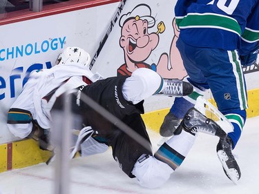 San Jose Sharks' Brenden Dillon crashes into the boards after being hit by Vancouver Canucks' Derek Dorsett during the third period of a pre-season NHL hockey game in Vancouver, B.C., on Sunday October 2, 2016.