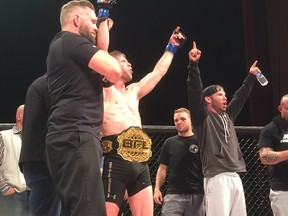Cole Smith (center) and his team react to his bantamweight championship win at BFL Fight Night 46 Saturday in Coquitlam.