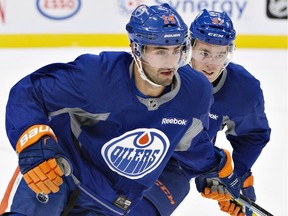 Jordan Eberle (in foreground) is eager to rekindle his promising chemistry with linemate Connor McDavid this coming season. Here the duo dig in during a hard skating session at training camp last month in Edmonton.