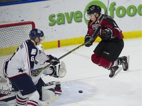 James Malm of the Vancouver Giants leaps in front of the Tri-City Americans' net on Sunday at Langley Event Centre . Malm scored in the third period but the Giants lost 5-4.