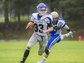 Ballenas' Logan Pepper is pursued by Seaquam defensive end Dedaar Jhooty on Saturday in North Delta. (Arlen Redekop, PNG photo)