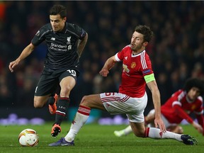 Philippe Coutinho of Liverpool evades Michael Carrick of Manchester United during a UEFA Europa League game in March.