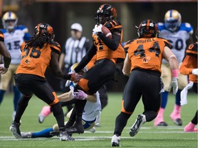 B.C. Lions safety Mike Edem hangs on for one of his two interceptions Friday against the Winnipeg Blue Bombers.