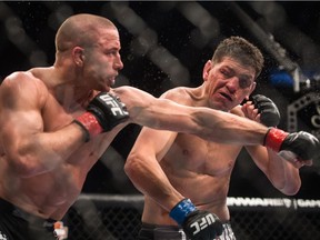 Georges St-Pierre punches Nick Diaz in 2013. The Montrealer revealed Monday that he was no longer under contract with the UFC.