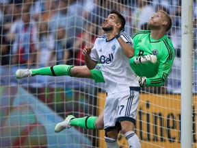 Vancouver Whitecaps captain Pedro Morales and goalkeeper David Ousted are shown tracking a ball last year, but they're not seeing eye to eye these days.