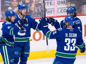 Pleased to meet you: The well-established veterans Daniel (second from left) and Henrik Sedin will hope that newcomers Philip Larsen (far left) and particularly Loui Eriksson (far right) add some vital offensive punch up front for the Vancouver Canucks this season, particularly on the power play.