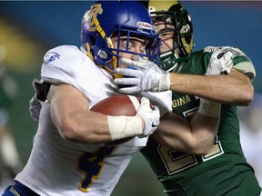 UBC Thunderbirds Ben Cummings, left, and University of Regina Rams Joey Dwyer get tangled up at Mosaic Stadium in Regina. TROY FLEECE / Regina Leader-Post