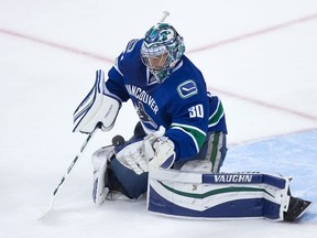 Vancouver Canucks' goalie Ryan Miller makes a glove save against the San Jose Sharks during the third period of a pre-season NHL hockey game in Vancouver, B.C., on Sunday October 2, 2016.