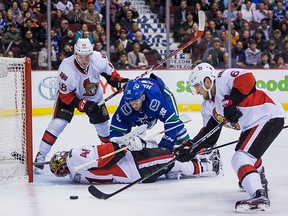 Canucks Right Wing Jannik Hansen (36) watches the puck go through the pads of Ottawa Senators Goalie Craig Anderson (41) as Ottawa Senators Left Wing Ryan Dzingel (18) and  Defenceman Chris Wideman (6) look on.