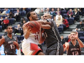 Simon Fraser's Iziah Sherman-Newsom, left, tries to drive past Malcolm Mensah of Douglas College during an exhibition basketball game Saturday atop Burnaby Mountain. Ron Hole/SFU athletics