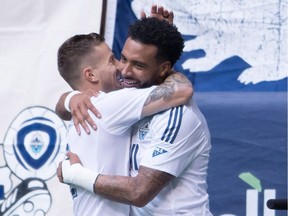 Vancouver Whitecaps' Tim Parker, left, and Giles Barnes celebrate Barnes' first goal against the Portland Timbers during the first half of an MLS soccer game in Vancouver, B.C., on Sunday October 23, 2016.